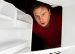 Man looks to his fridge for a snack