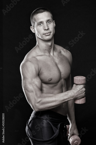 Photo: Black and white photo of sexy sportsman with dumbbells Black and white photo of sexy sportsman with dumbbells