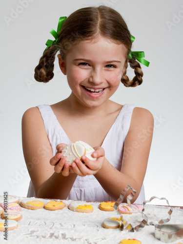Photo: Happy easter - lovely girl making easter cookies Happy easter - lovely girl making easter cookies