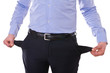Young business man pulling out empty pockets.