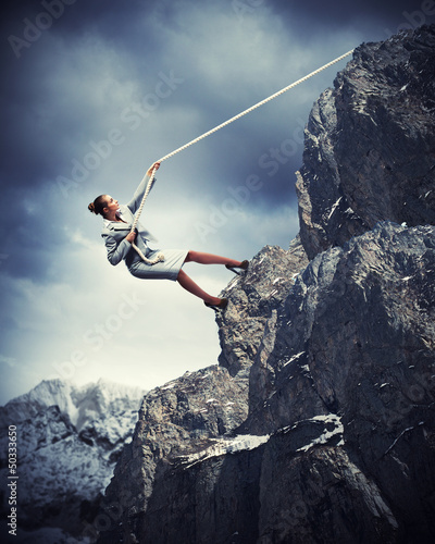 Photo: businesswoman climbing mountain businesswoman climbing mountain