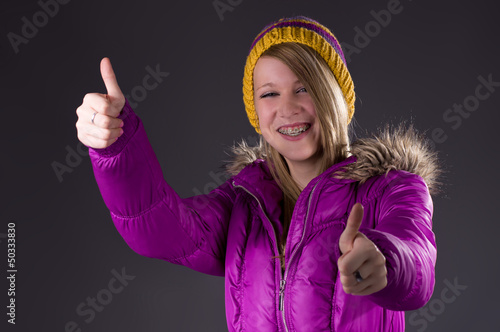Photo: Teen in winterclothes thumbs up Teen in winterclothes thumbs up