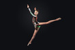 Young woman in gymnast suit posing