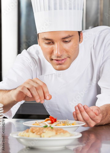 Photo: Chef Sprinkling Spices On Dish Chef Sprinkling Spices On Dish