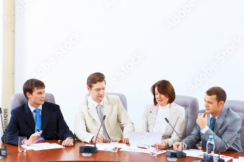 Photo: Four businesspeople at meeting Four businesspeople at meeting