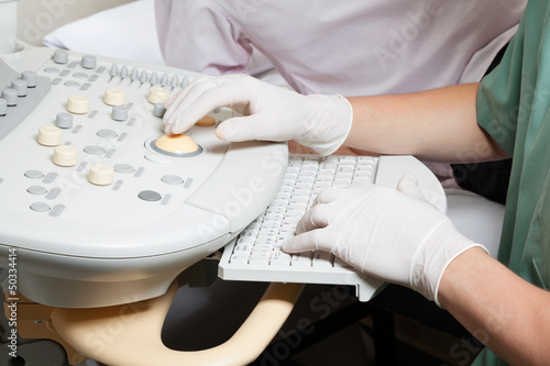 Photo: Technician Operating Ultrasound Machine Technician Operating Ultrasound Machine