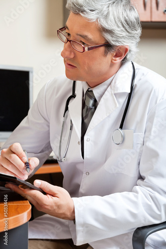 Photo: Mature Male Doctor In Clinic Mature Male Doctor In Clinic