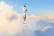 Businesswoman standing on ladder