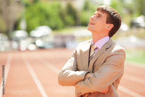 Photo: Businessman at athletic stadium and race track Businessman at athletic stadium and race track
