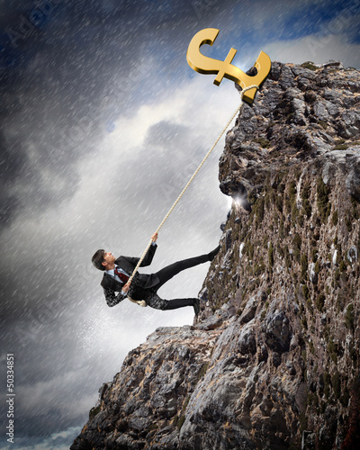 Photo: busiessman climbing mountain busiessman climbing mountain