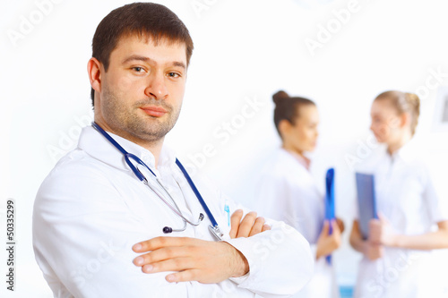 Photo: Young male doctor in white uniform Young male doctor in white uniform