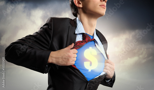 Photo: Businessman showing superman suit underneath shirt Businessman showing superman suit underneath shirt