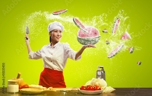 Photo: Asian female cook with knife Asian female cook with knife