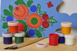Paints, brushes and cutting board.