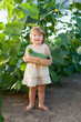 2 years baby girl picking cucumber