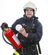firefighter is showing a smoke detector and extinguisher