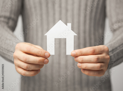 Photo: man holding paper house man holding paper house