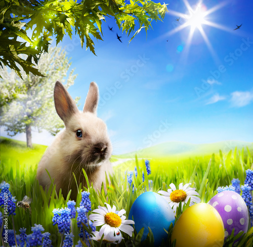 Photo: art Little Easter bunny and Easter eggs on green grass art Little Easter bunny and Easter eggs on green grass