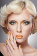 Beautiful woman face with luxury gold makeup