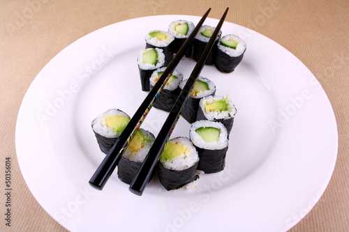 Photo: Sushi with chopsticks as a dollar sign Sushi with chopsticks as a dollar sign