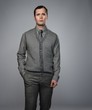 Confident man wearing grey vest and necktie isolated on grey
