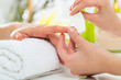 Woman in nail salon receiving manicure