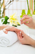 Woman in nail salon receiving manicure