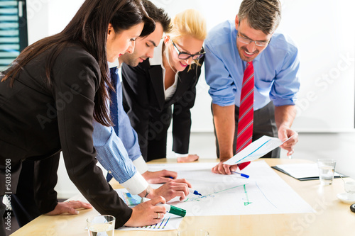 Photo: Business - People in office working as team Business - People in office working as team