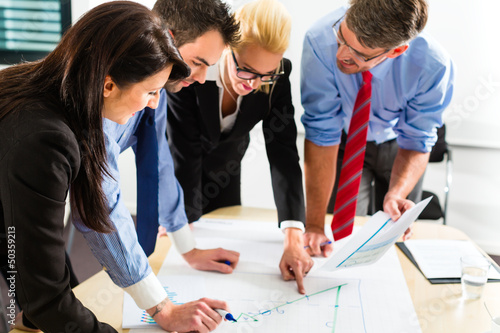 Photo: Business - People in office working as team Business - People in office working as team