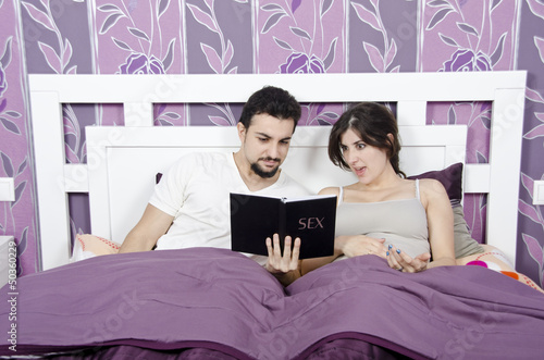 Photo: Reading a book about sex problems. Reading a book about sex problems.