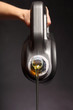 Can with car engine oil pouring black background