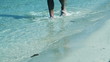 Male legs walking along the beach, slow motion shot at 120fps