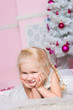 The girl at the Christmas fir-tree with gifts