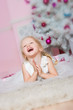 The girl at the Christmas fir-tree with gifts