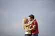 A young couple embracing in summertime