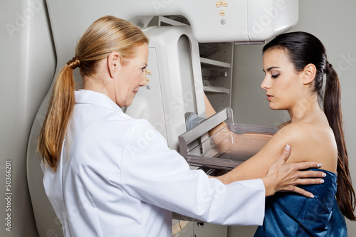 Photo: Doctor Assisting Patient Undergoing Mammogram Doctor Assisting Patient Undergoing Mammogram