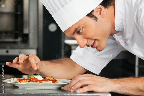 Photo: Male Chef Garnishing Dish Male Chef Garnishing Dish