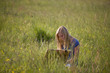 A young woman having a picnic in the countryside