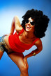Photo: Smiling tanned woman with afro hair posing Smiling tanned woman with afro hair posing