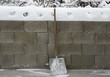 Wide shovel leaning against wall