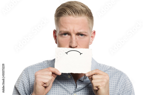 Photo: Upset businessman presenting blank white card. Upset businessman presenting blank white card.