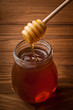 Honey drip in jar on the table
