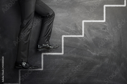 Photo: Climbing at the career stairs drawn on a chalkboard Climbing at the career stairs drawn on a chalkboard