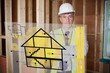 Architect standing behind house plan interface