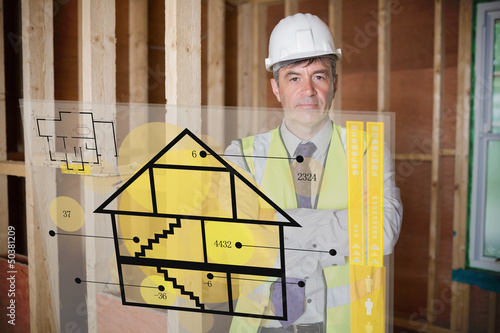 Photo: Architect standing behind house plan interface Architect standing behind house plan interface