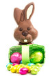 Easter eggs spilling from a basket with chocolate bunny