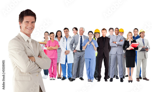 Photo: Businessman standing in front of different types of workers Businessman standing in front of different types of workers