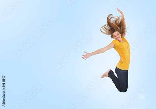 Photo: Pretty young woman jumping for joy Pretty young woman jumping for joy