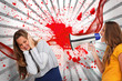 Girl shouting at friend through a megaphone