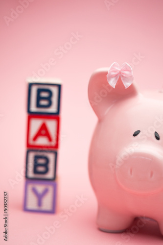 Photo: Piggy bank and blocks spelling baby Piggy bank and blocks spelling baby